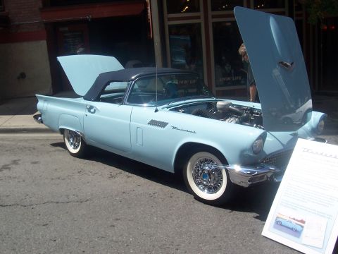 1972 Ford Ranchero - A classic light blue convertible is displayed with its hood and trunk open, revealing the engine and interior.
