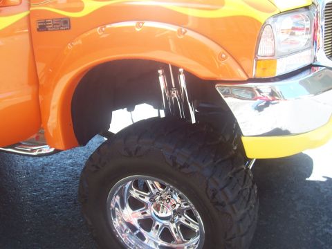1972 Ford Ranchero - Customized Ford F-350 Super Duty truck with flame graphics and aftermarket wheels.