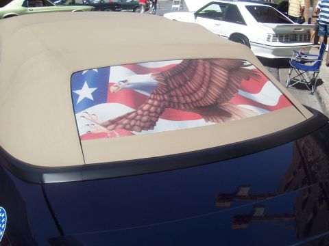 1972 Ford Ranchero - A convertible top features a graphic of an eagle in flight against the American flag, with other vehicles in the background.