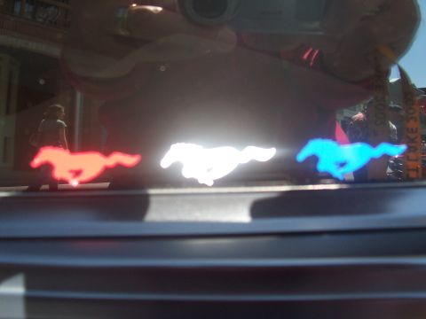 1972 Ford Ranchero - Reflection shows three illuminated running horse emblems in red, white, and blue.
