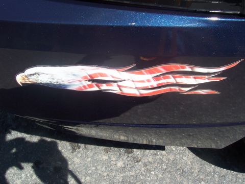 1972 Ford Ranchero - A close-up of a patriotic decal an eagle and the American flag on the side of a blue vehicle.
