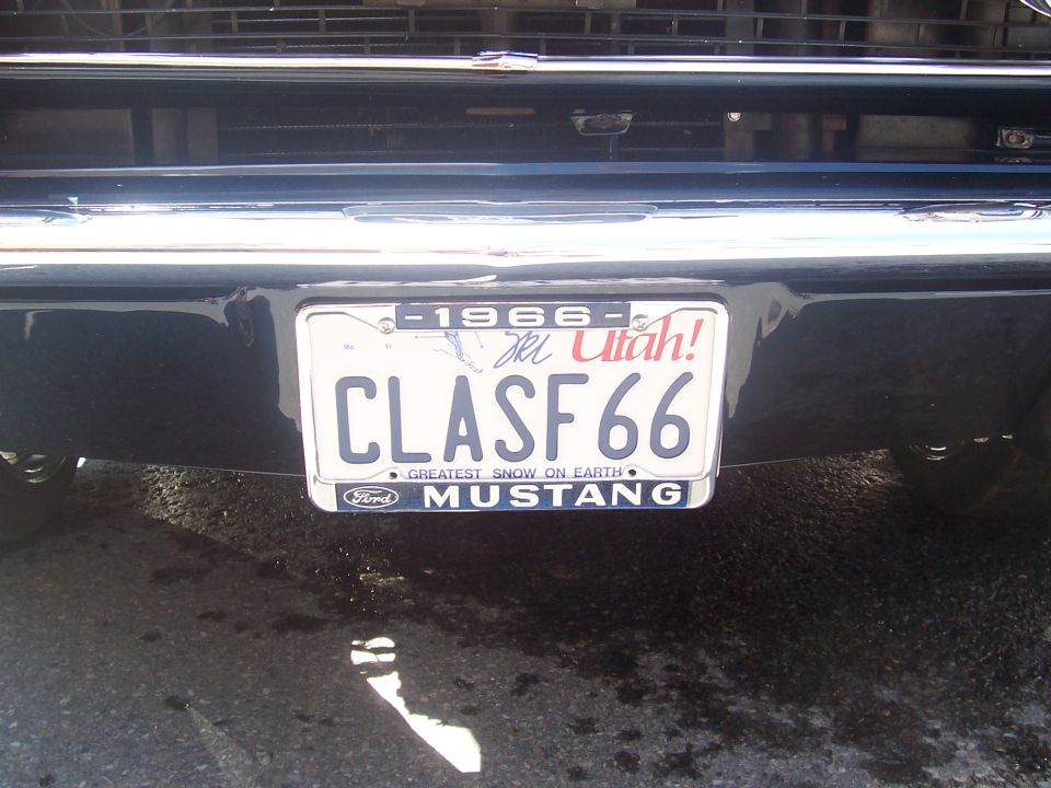 Rear view of a black car with a Utah license plate reading CLASF 66 and "Ford MUSTANG" below