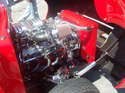1972 Ford Ranchero - Engine bay details of a red vehicle, a polished chrome engine and air intake.