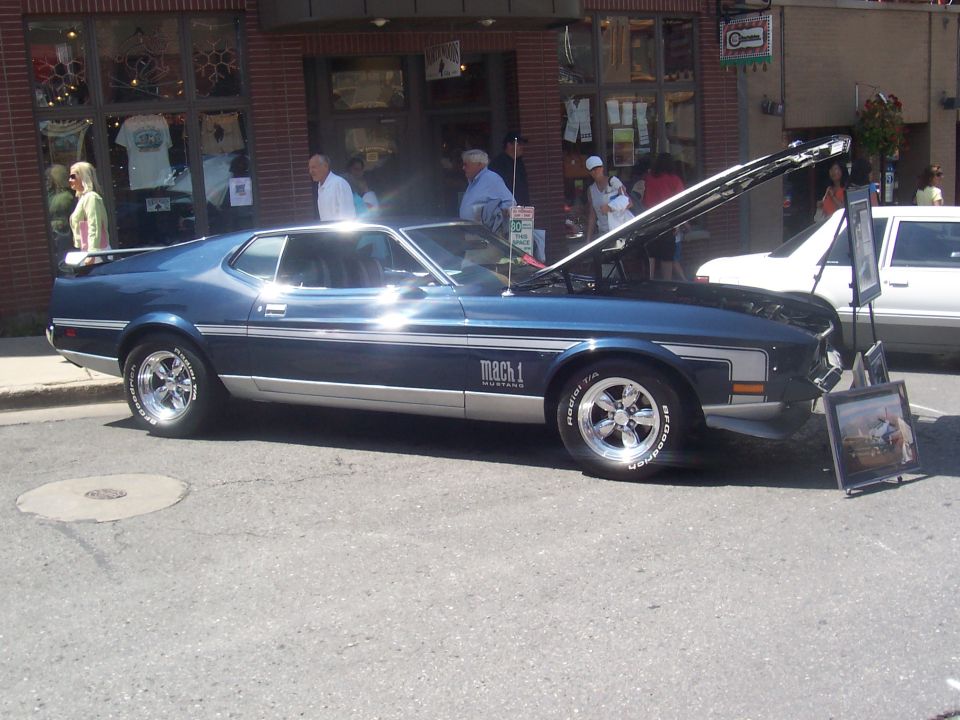 1971 Ford Mustang Mach 1 with hood open, parked on street
