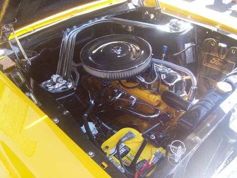1972 Ford Ranchero - A close-up view of a car's engine bay, a chrome air filter and yellow engine components.