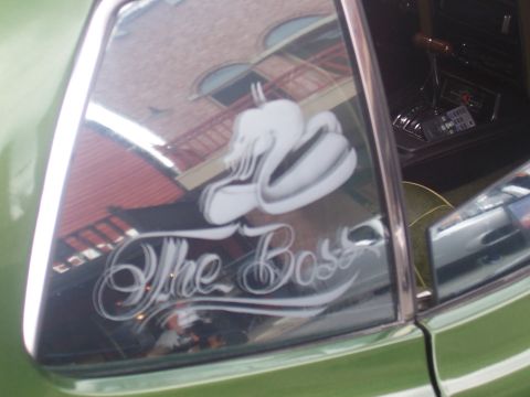 1972 Ford Ranchero - Custom airbrushed swan and "The Boss" lettering adorn the window of this green vehicle.