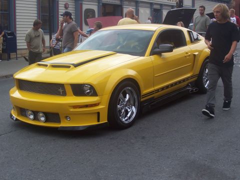 1972 Ford Ranchero - Yellow 2005 Ford Mustang with racing stripes and custom wheels.