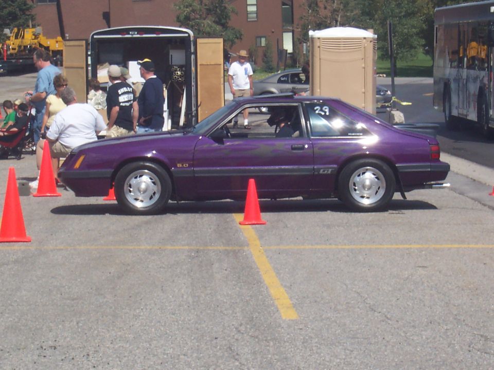 Purple Ford Mustang GT with flame graphics and a 'GT' badge