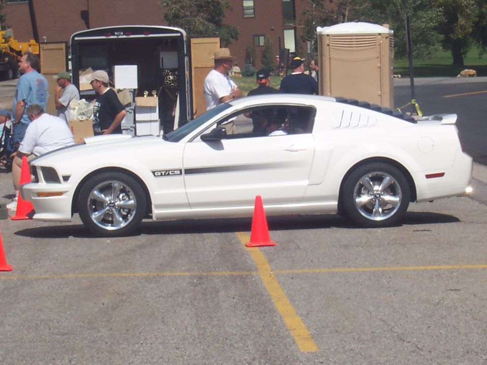 White coupe with GT/CS badging parked on asphalt