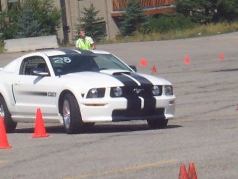 1972 Ford Ranchero - White 2005 Ford Mustang with black stripes and number 28 on windshield, driving through cones.