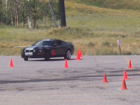 1972 Ford Ranchero - A black Ford Mustang with racing stripes and the number 2 navigates a course marked by orange traffic cones.