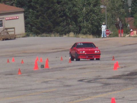 1972 Ford Ranchero - A red coupe, marked with the number 155, maneuvers through an autocross course.