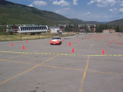 1972 Ford Ranchero - Car drives through an autocross course set up in a large paved area.