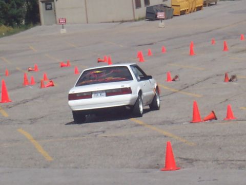 1972 Ford Ranchero - A white coupe navigates a course marked by orange cones.