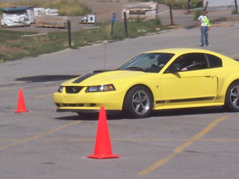 1972 Ford Ranchero - Yellow coupe with black racing stripes navigates a course marked by orange cones.