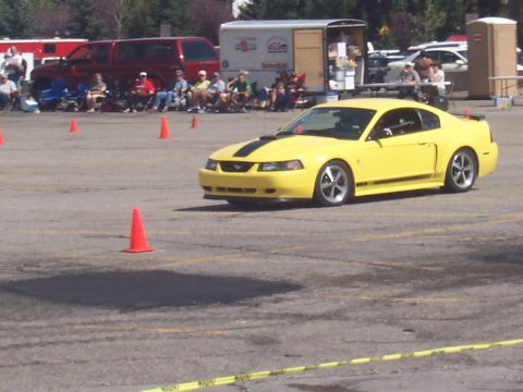 1972 Ford Ranchero - Yellow 2000 Ford Mustang GT coupe navigates an autocross course marked by orange cones.
