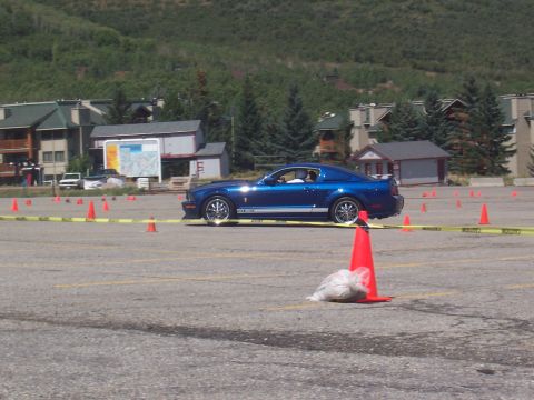 1972 Ford Ranchero - A blue Ford Mustang Shelby GT500 is parked in a lot marked with cones and yellow caution tape.
