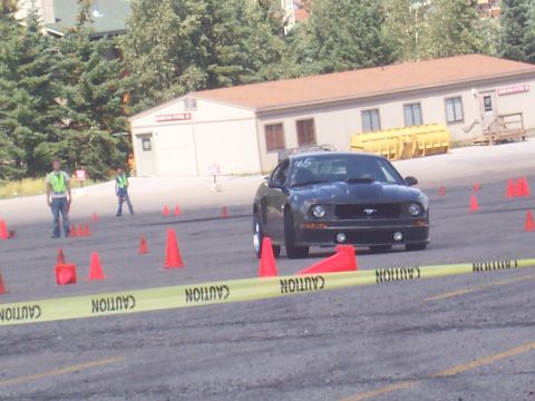 1972 Ford Ranchero - Ford Mustang participating in a timed driving event with caution tape and cones visible.