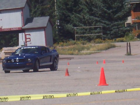 1972 Ford Ranchero - A blue Ford Mustang is seen on a track, navigating around orange cones.