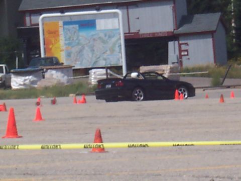 1972 Ford Ranchero - A black convertible sports car is seen on a track with cones, possibly during a driving event.