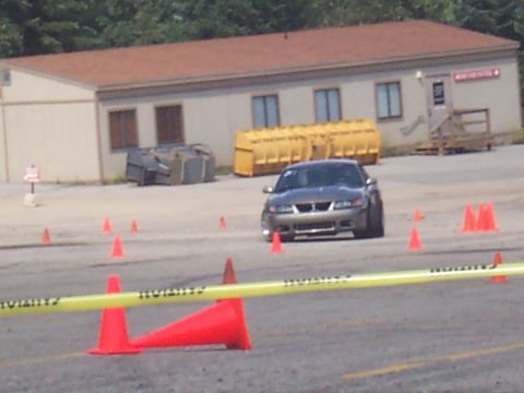 1972 Ford Ranchero - Silver Ford Mustang driving on a track with cones and caution tape.
