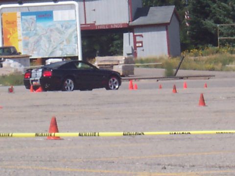 1972 Ford Ranchero - A black sports car is positioned on a course marked by cones and caution tape, with a ski resort map in the background.