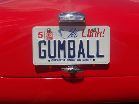 1972 Ford Ranchero - Utah license plate on a red car reads GUMBALL and has an expiration date of 5/08.