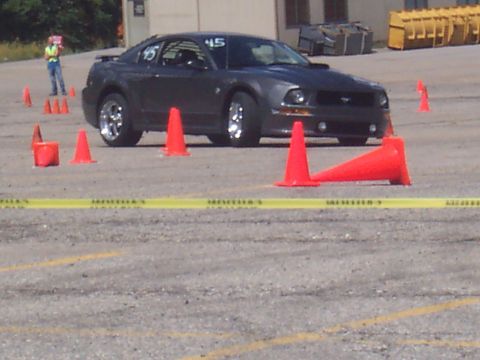 1972 Ford Ranchero - Dark gray Ford Mustang with racing number 45 on the door, set up for an autocross event.