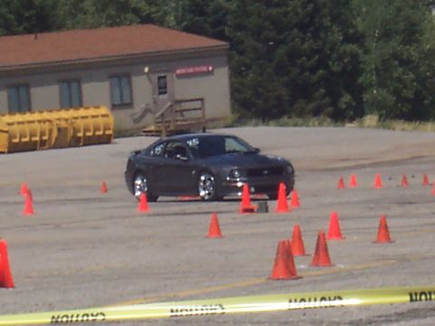 1972 Ford Ranchero - A dark coupe is seen on an autocross course, marked by orange cones.