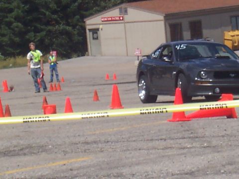 1972 Ford Ranchero - Ford Mustang participating in a timed event with cones and safety personnel present.