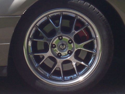 1972 Ford Ranchero - A close-up view of a vehicle's wheel and tire, with a red brake caliper peeking through the spokes.