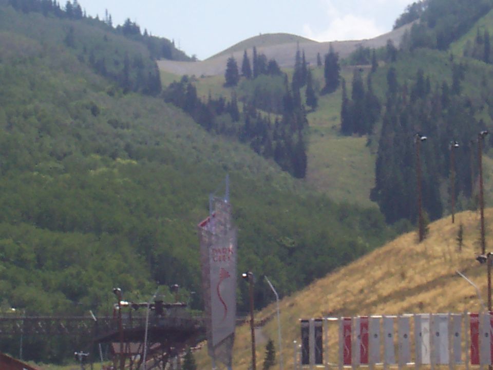 Park City sign on a mountainside with ski slopes