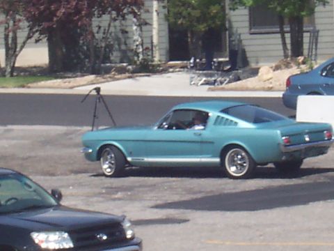 1972 Ford Ranchero - Light blue 1965 Ford Mustang coupe parked outdoors, with another vehicle in the foreground.