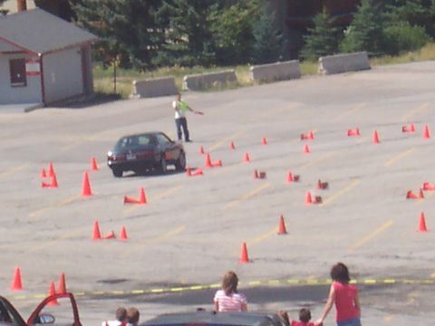 1972 Ford Ranchero - A car is driven through a parking lot marked with cones, possibly for a driving event.