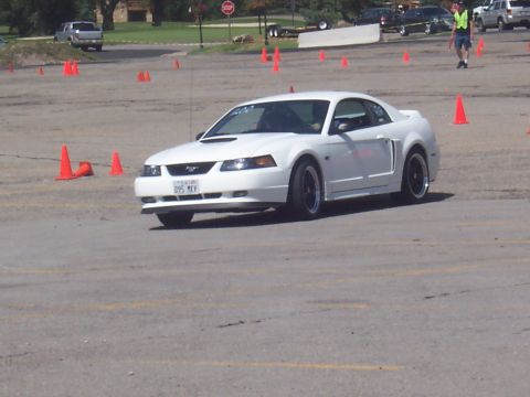 1972 Ford Ranchero - A white Ford Mustang is driven around a course marked by orange cones.