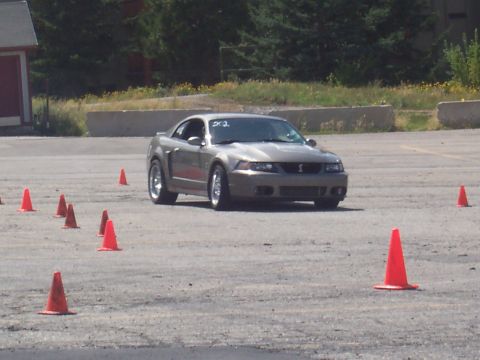 1972 Ford Ranchero - A silver Ford Mustang Cobra navigates a course marked by orange traffic cones.