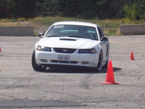 1972 Ford Ranchero - White 2000 Ford Mustang navigating a course marked by orange cones.