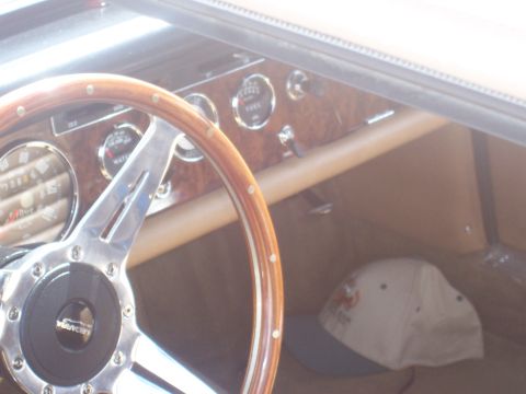 1972 Ford Ranchero - Interior view of a vehicle's dashboard, a wood-rimmed steering wheel and various gauges.