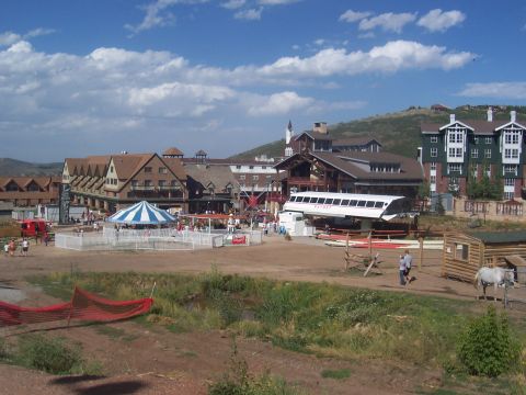 1972 Ford Ranchero - A scenic view of a ski resort village, complete with a carousel and ski lift, on a sunny day.