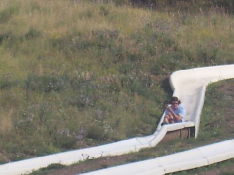 1972 Ford Ranchero - A person is riding down a long, winding slide in a grassy outdoor area.