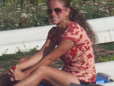 1972 Ford Ranchero - A woman relaxes outdoors on a sunny day, wearing sunglasses and a patterned shirt.