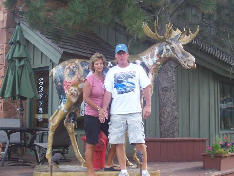 1972 Ford Ranchero - Couple poses with a large, artfully painted moose statue outside a building with a coffee sign.