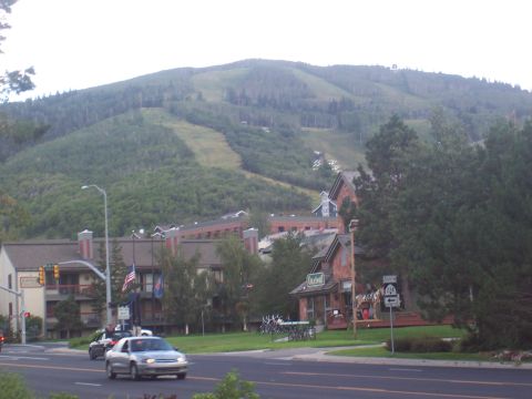 1972 Ford Ranchero - A view of a mountain town with buildings and trees, with ski slopes visible on the mountain in the background.