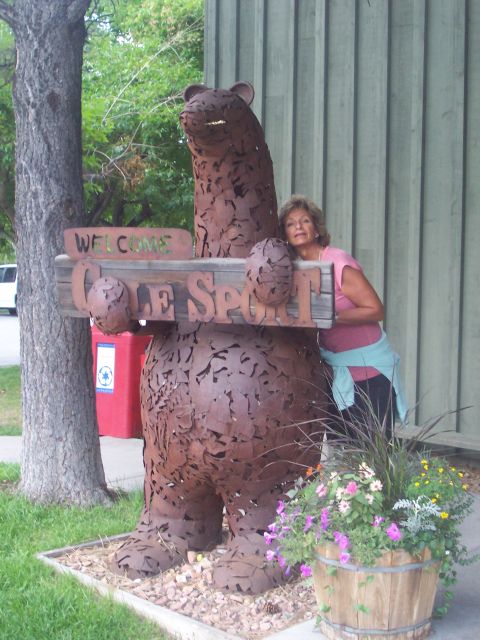 1972 Ford Ranchero - Woman poses with a large metal bear sculpture that holds a welcome sign.