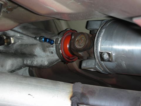 1992 Ford Crown Victoria - Close-up view of the driveshaft and transmission connection, showing custom fittings and a red seal.