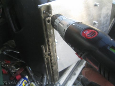 1987 Suzuki Samurai - A power drill is used to attach a seat mounting bracket, suggesting interior work on a vehicle.