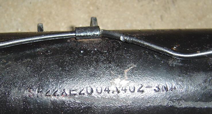 Close-up of a metal tube with part number SR22XE2004A402-3NA stamped on it