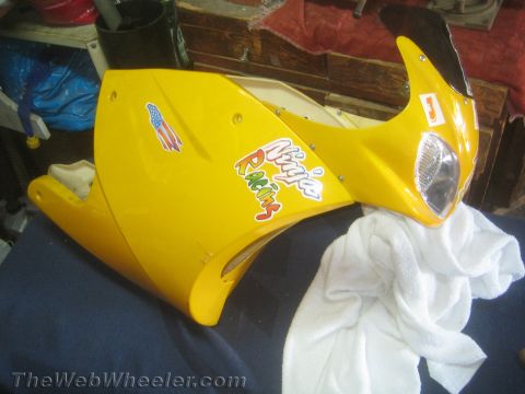 1968 Ford Mustang - A yellow motorcycle fairing with 'Ninja Racing' stickers is displayed, with a white towel draped over it.
