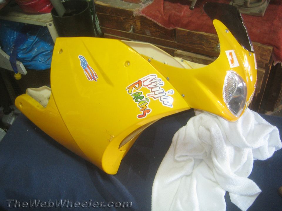 Yellow motorcycle fairing with Ninja Racing stickers and an American flag decal