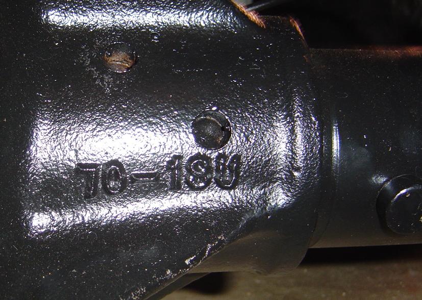 Close-up of a black metal part with casting numbers '70-189' visible